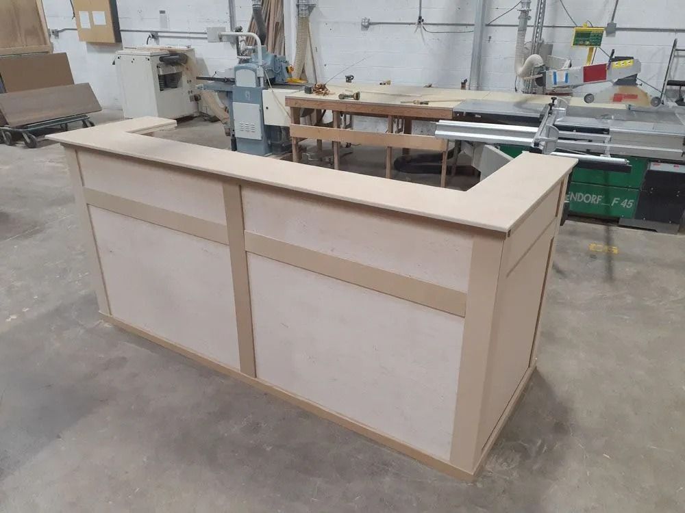 Wooden rectangular bar under construction in a workshop.