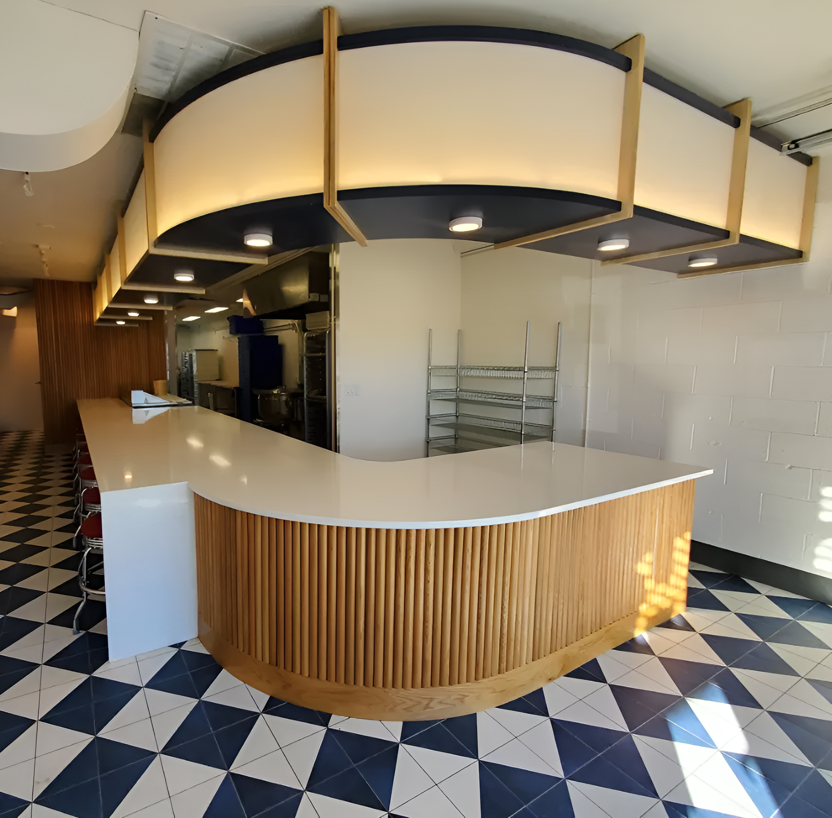 Kitchen with light wood cabinets, stainless steel appliances, granite countertops, and stone backsplash.