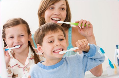 Happy family brushing their teeth