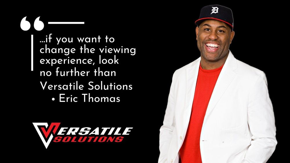 Man in white jacket, red shirt, and baseball cap smiles. Text reads: "Versatile Solutions." Quote: "...change the viewing experience..."