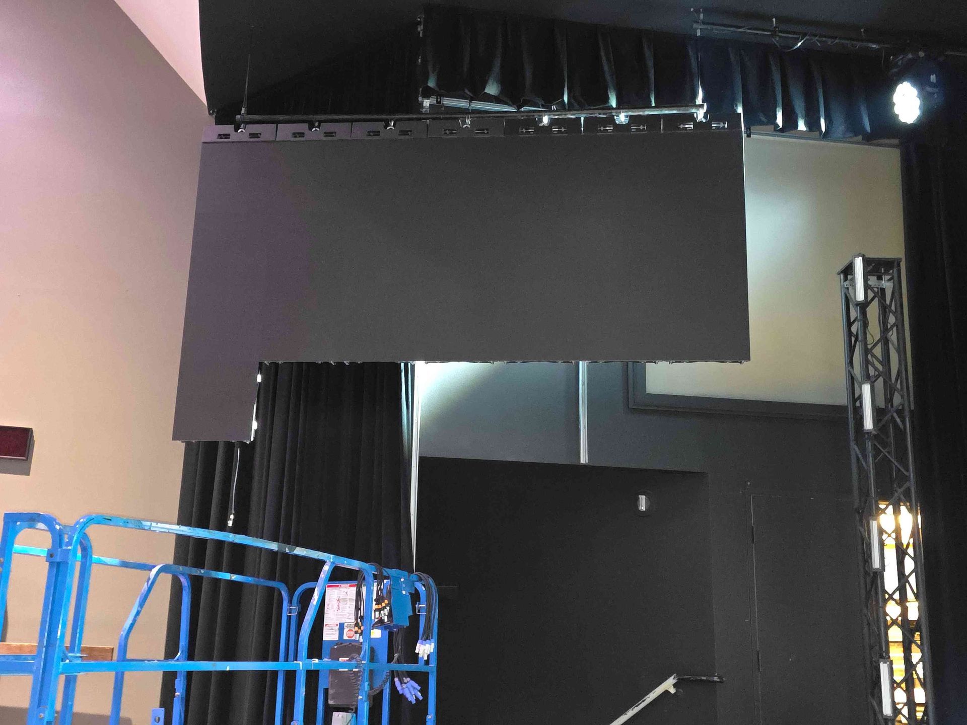 Large black LED screen, stage setting, partial view, with a lift in front.
