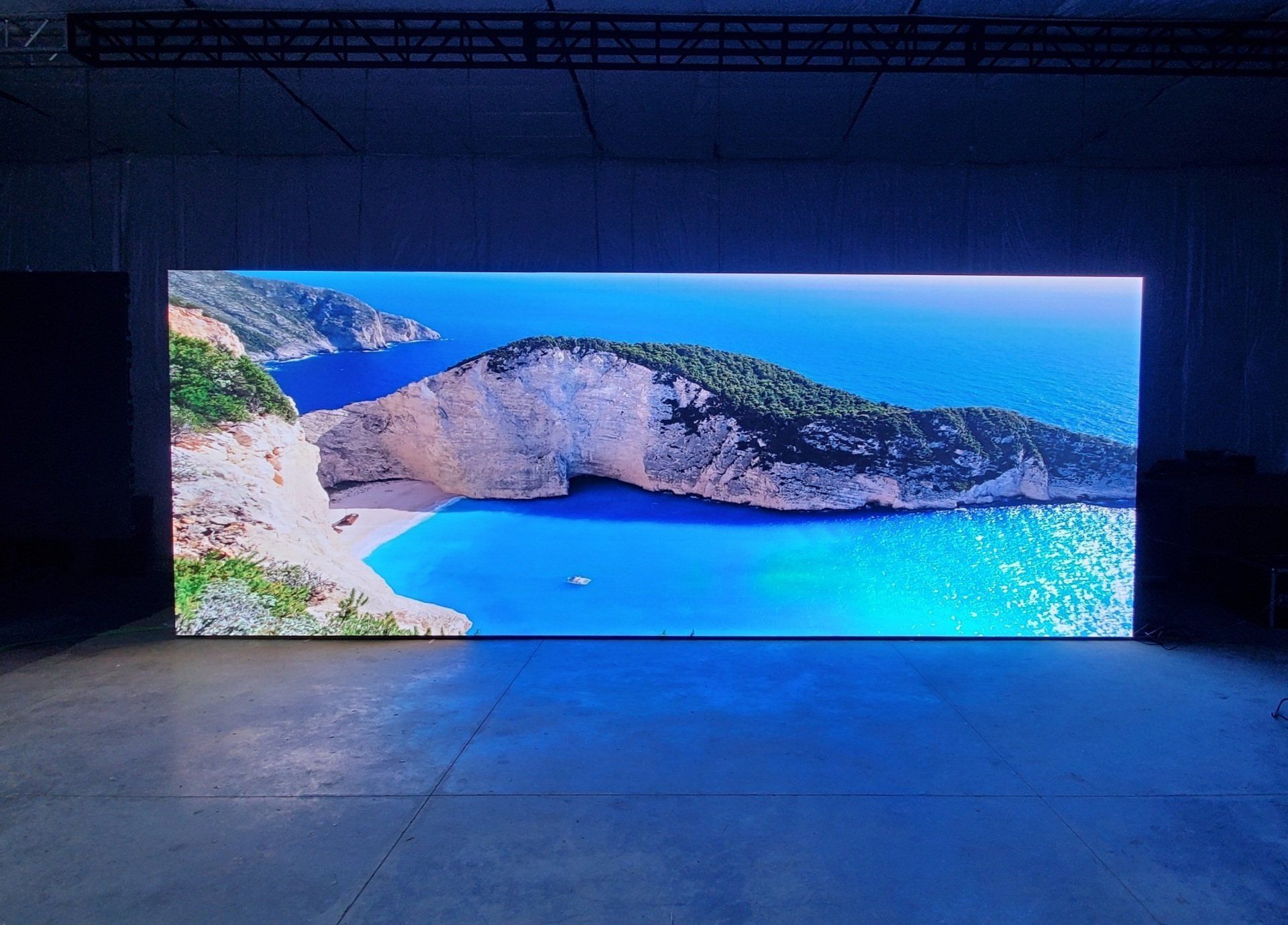 Large LED screen displaying a vibrant beach scene.