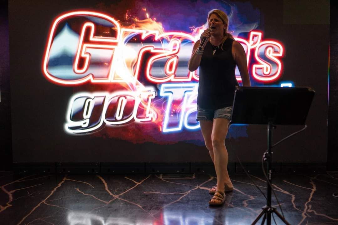 Woman singing on stage at 