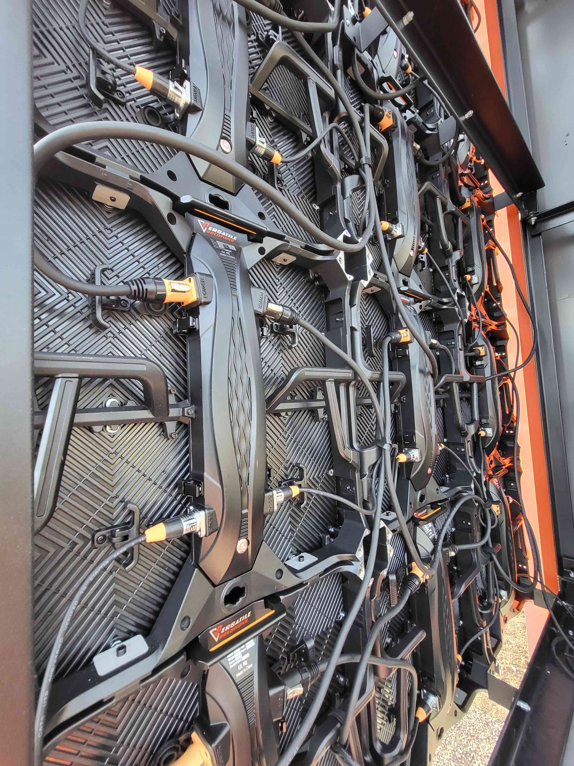 Back of a large LED screen showing black panels, wiring, and connectors.