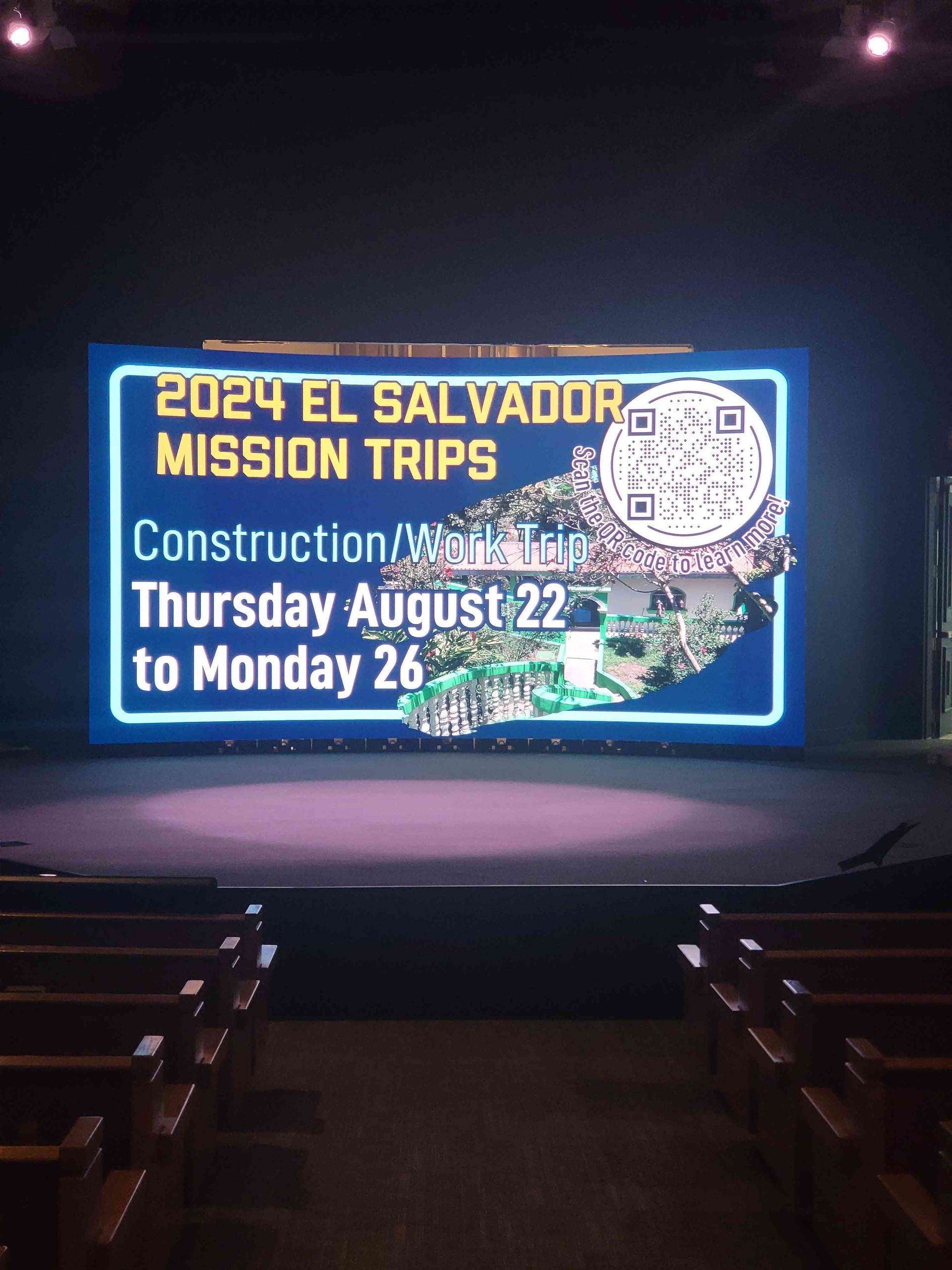 Sign promoting 2024 El Salvador mission trips, blue background, with construction/work dates of August 22-26.