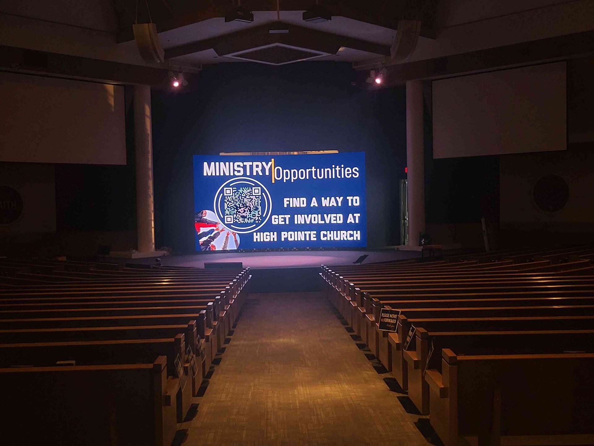 Empty church sanctuary; screen on stage reads 
