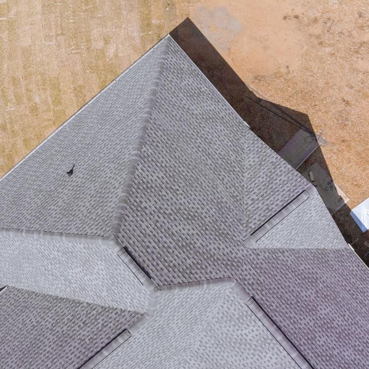 An aerial view of a house with a gray roof.