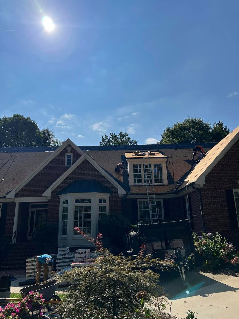 A brick house with a roof that is being installed.