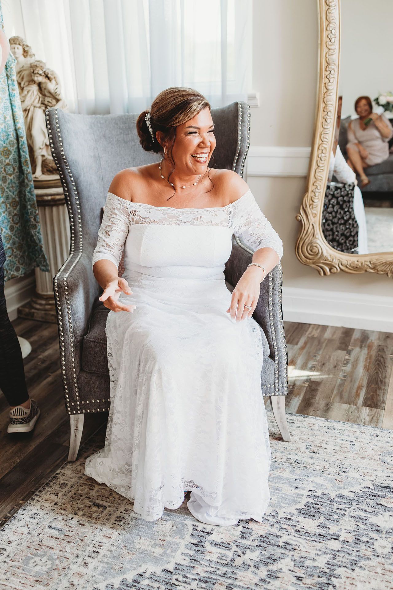A woman in off-the-shoulder lace wedding dress
