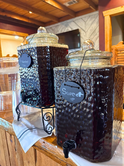 A couple of jars sitting on top of a wooden table.