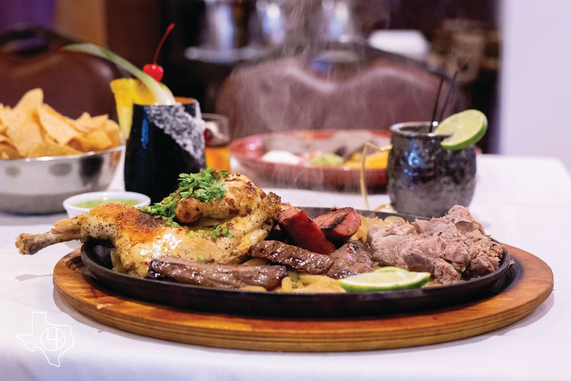 a plate of meat and vegetables on a wooden cutting board on a table