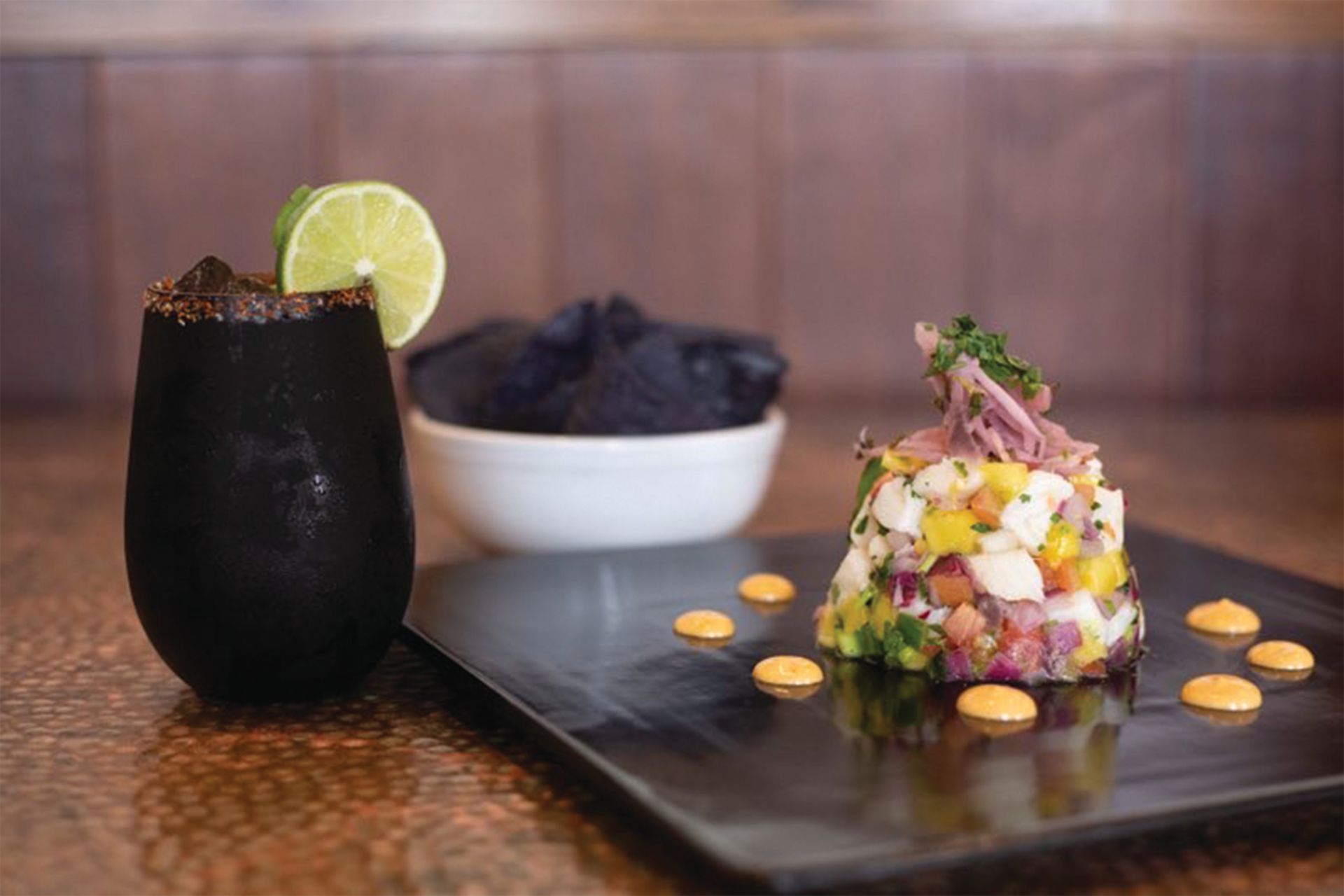 a plate of food and a glass of beer on a table