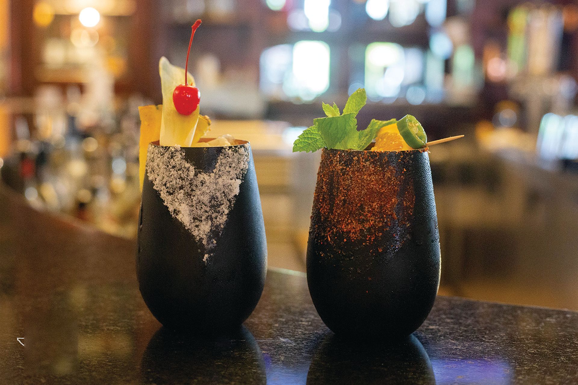 two drinks are sitting on a bar counter