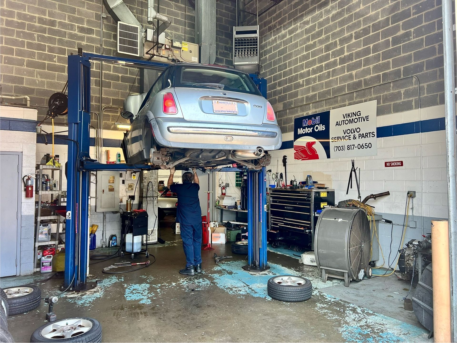 A car is sitting on a lift in a garage