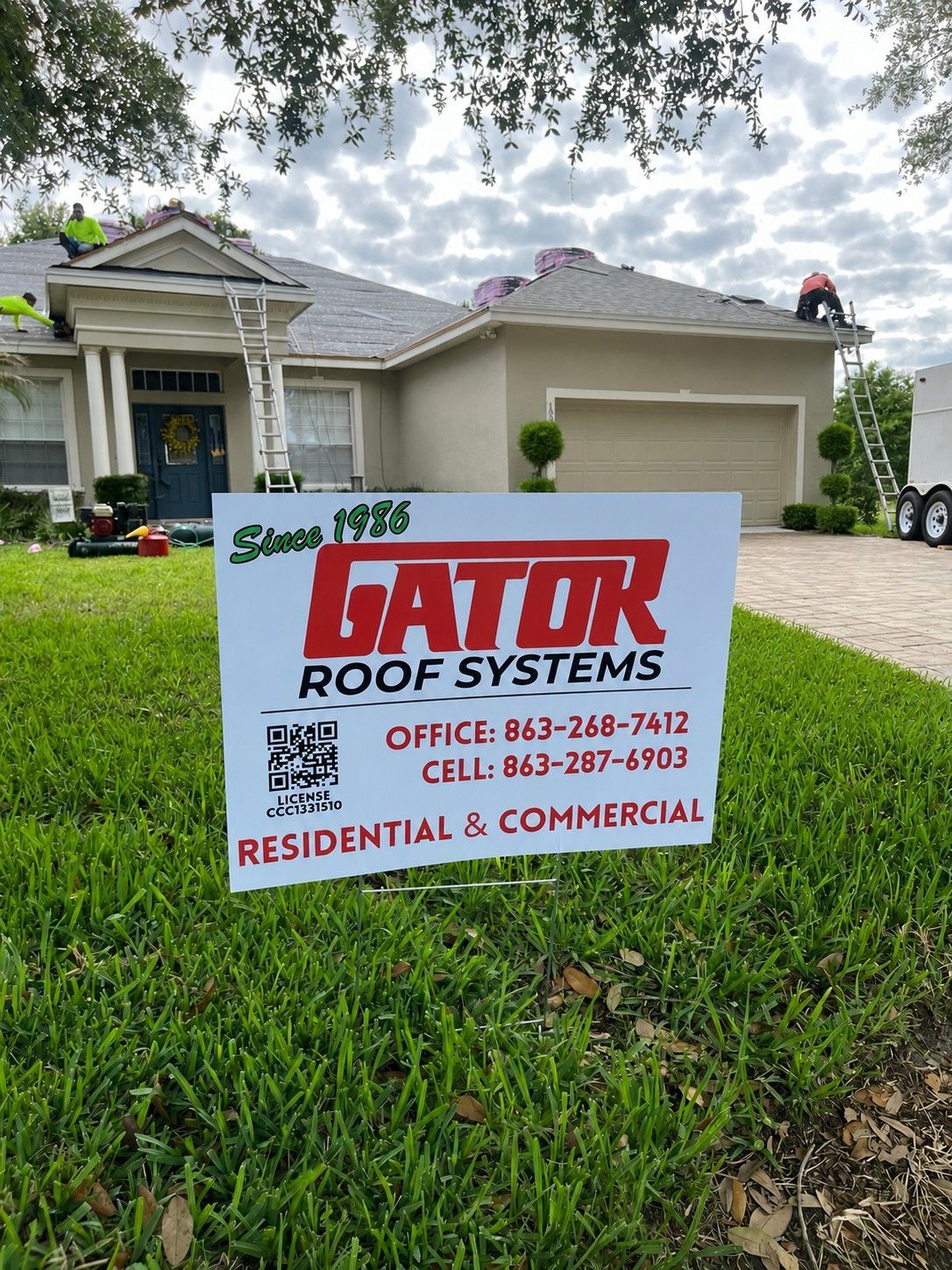 Lawn sign for Hator Roof Systems in front of a suburban house.