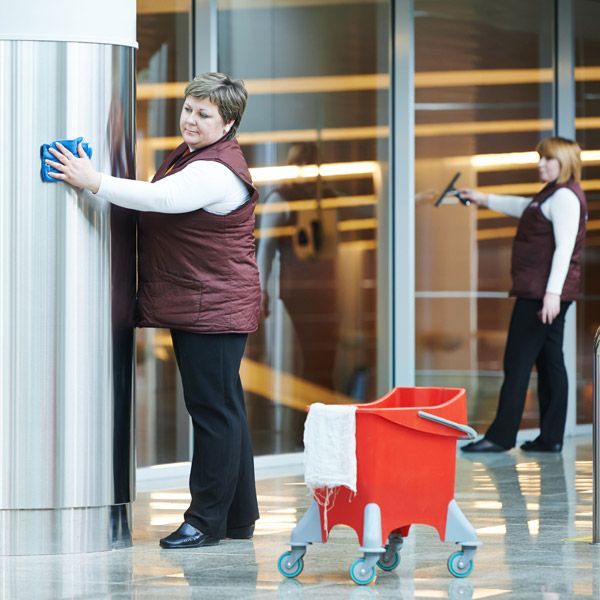 A woman is cleaning an office lobby