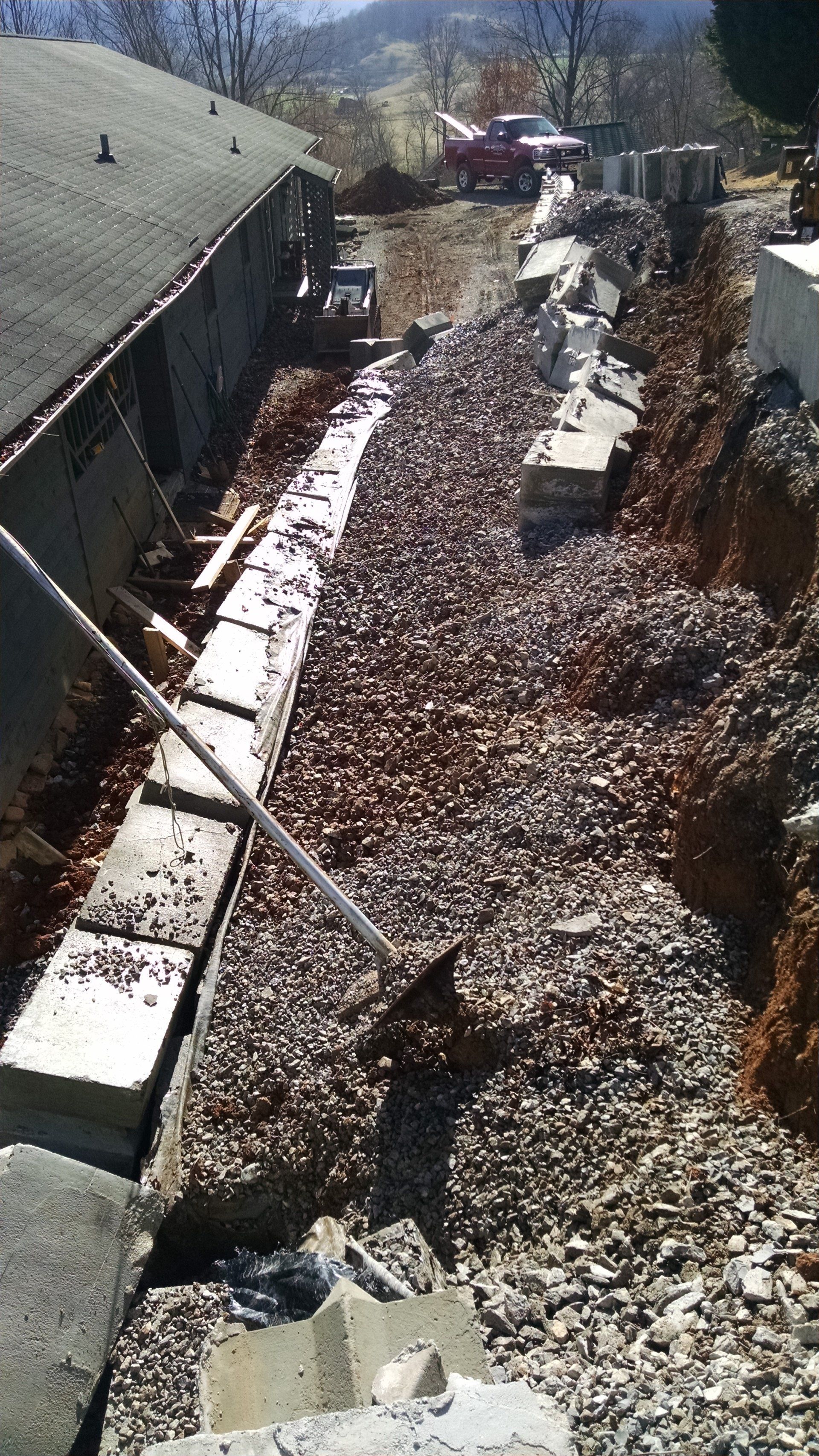 Engineered footer for reconstruction of wall failure