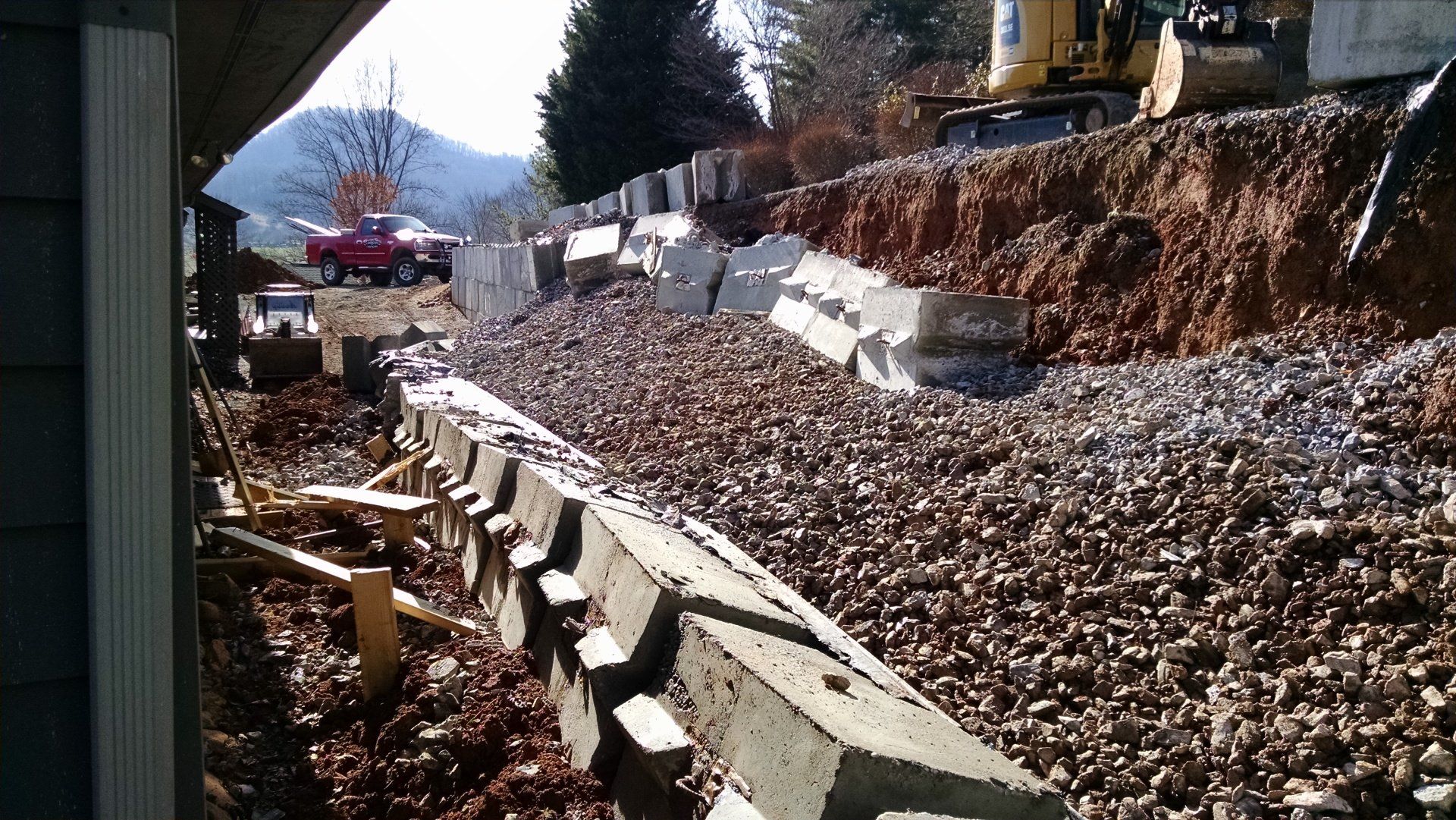 Engineered footer for reconstruction of wall failure