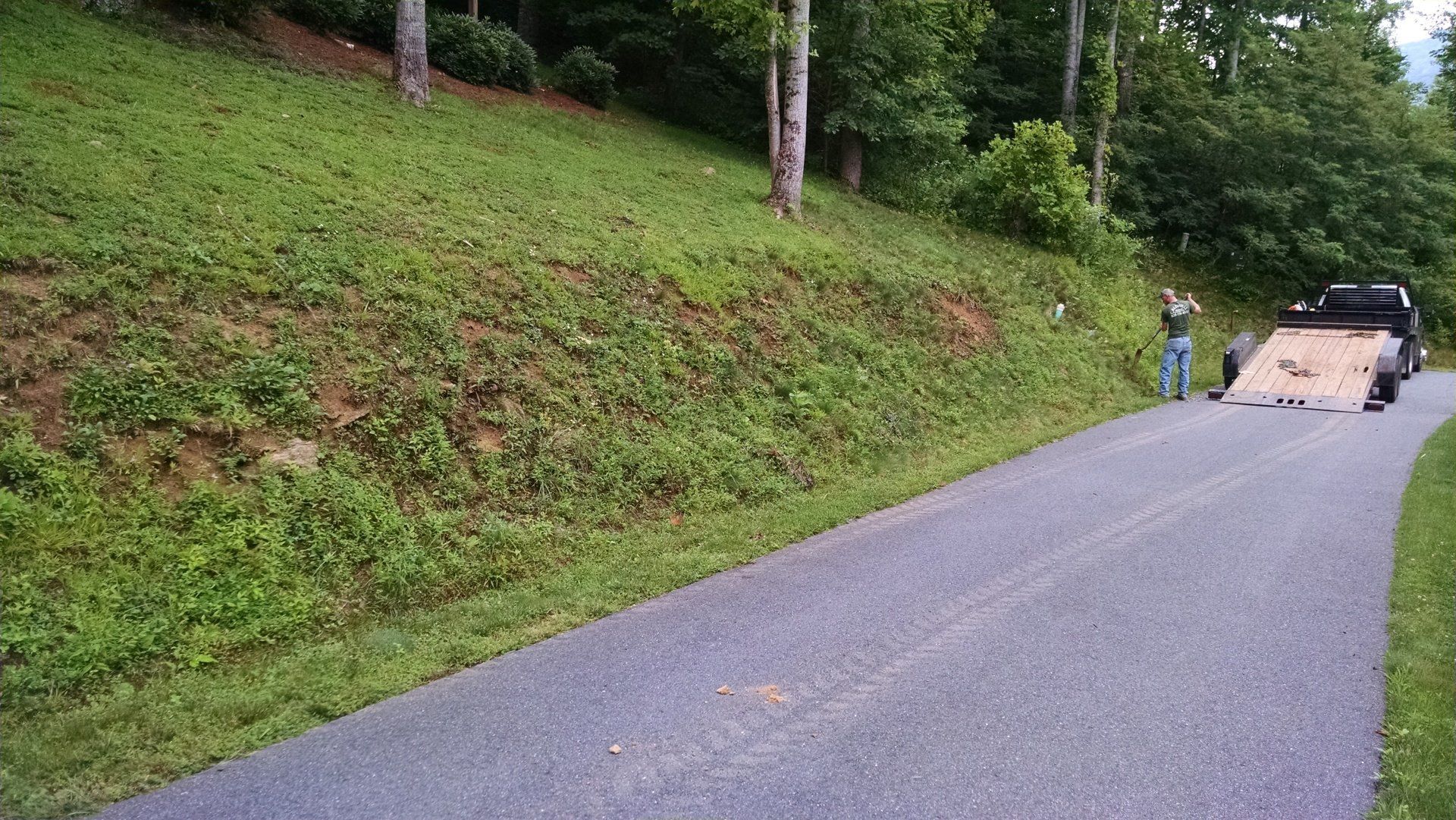 Beginning start to a boulder wall, with landscaping.