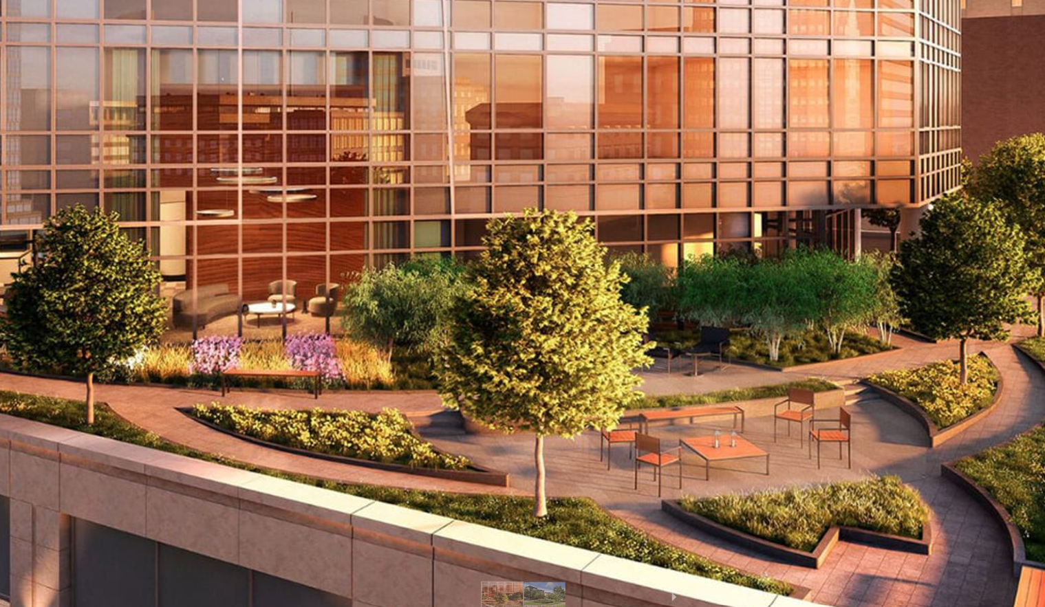 A park with a lot of trees and bushes in front of a building.