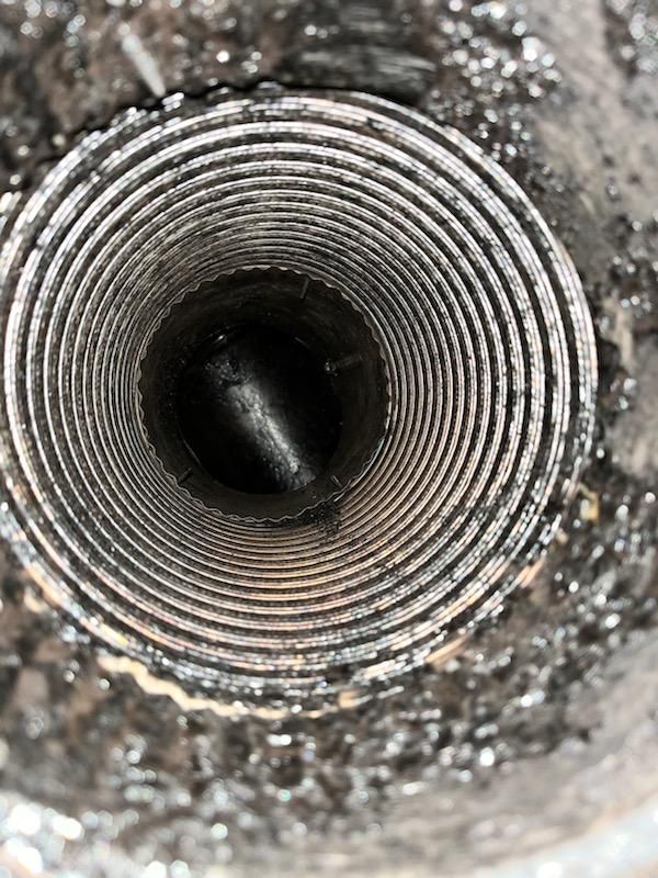 A close up of a metal pipe with a hole in the middle.