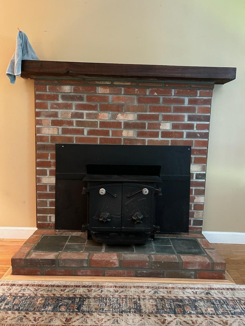 A brick fireplace with a wood stove in it