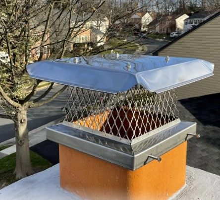 A chimney with a metal cover on top of it.