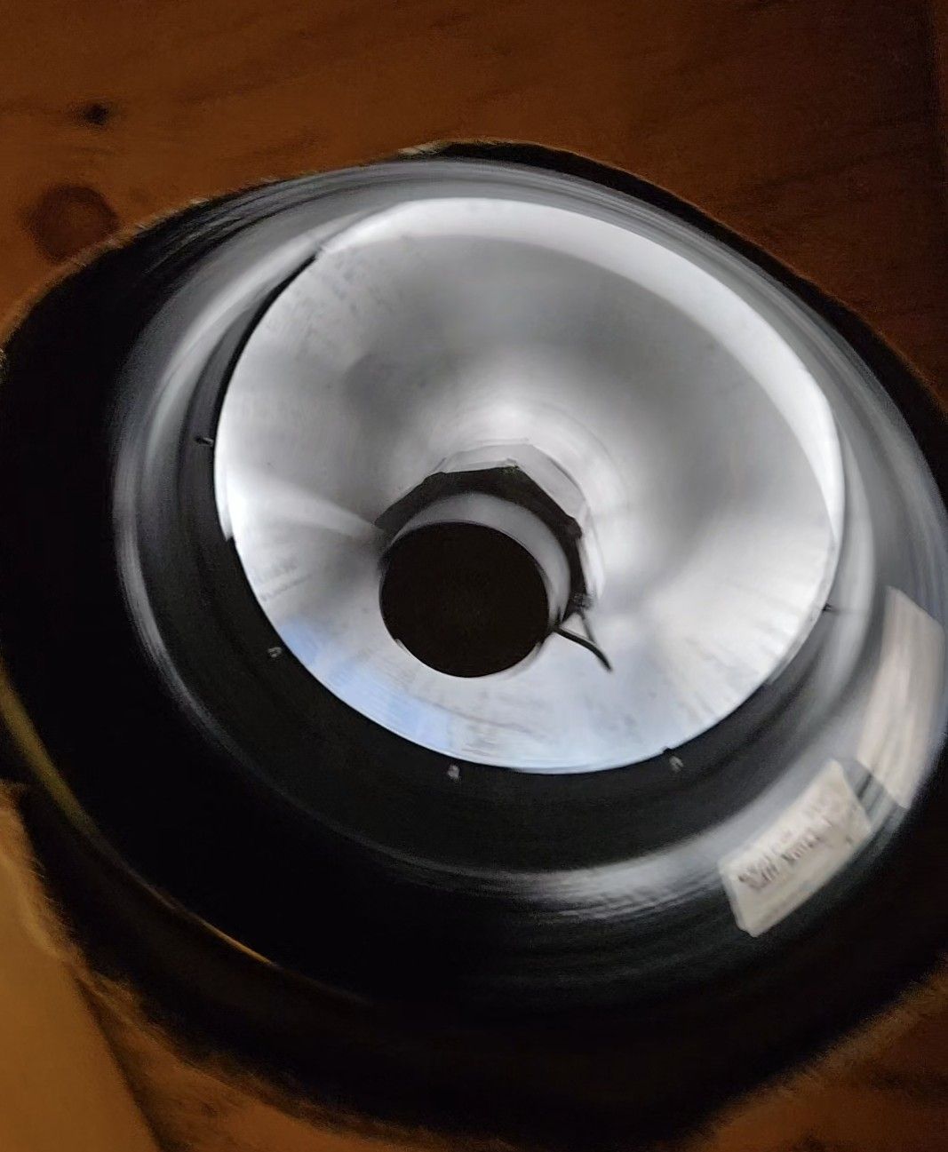 A close up of a metal object with a hole in the middle