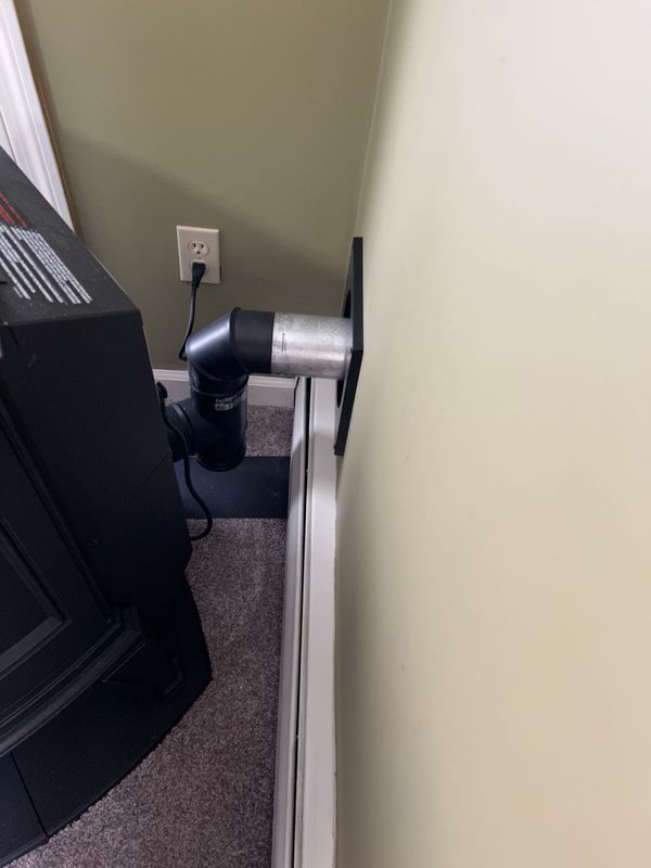 A tv mounted to a wall with a hose attached to it