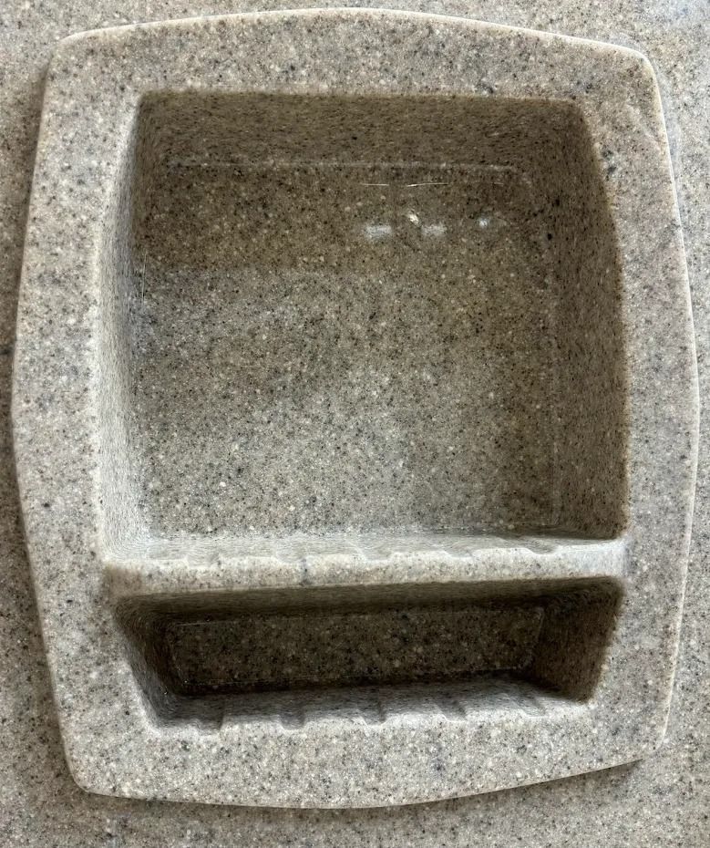 Stone pet water fountain with a square basin and small lower trough
