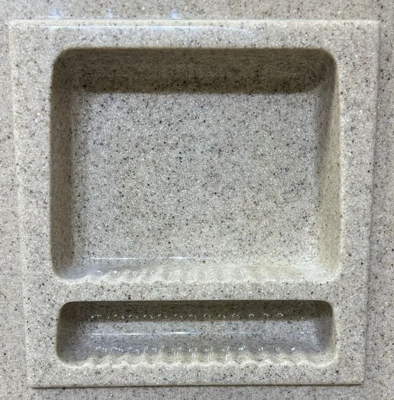 Gray speckled granite sink basin with a large square compartment and narrow lower trough