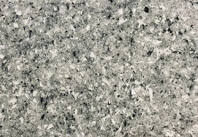 Close-up of gray speckled granite texture with black and white flecks