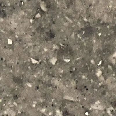 Close-up of a gray speckled stone or concrete surface with small white flecks