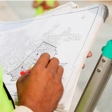 Contractor's hand checking the land division map