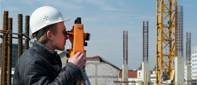 Surveyior checking the site to build