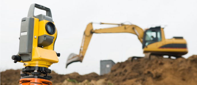 Surveying tool for site and excavator on background