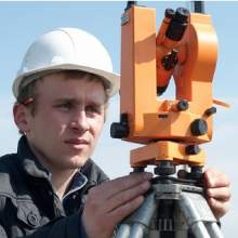 Contractor looking at the surveying tool