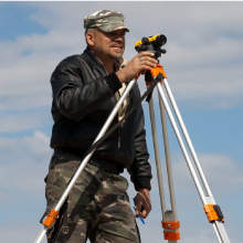 Contractor holding the surveying tool