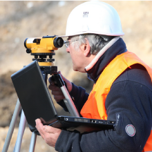 Surveyor looking at the scope of surveying tool