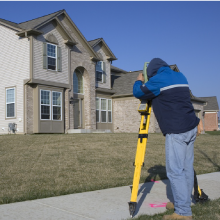 Surveyor surveying the house