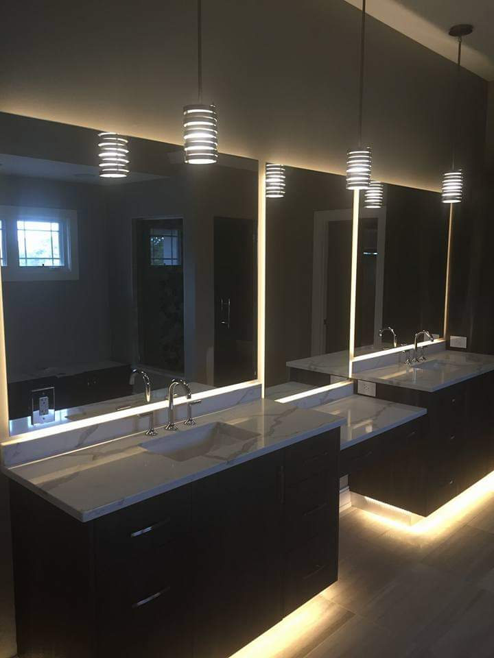 A bathroom with two sinks and a large mirror