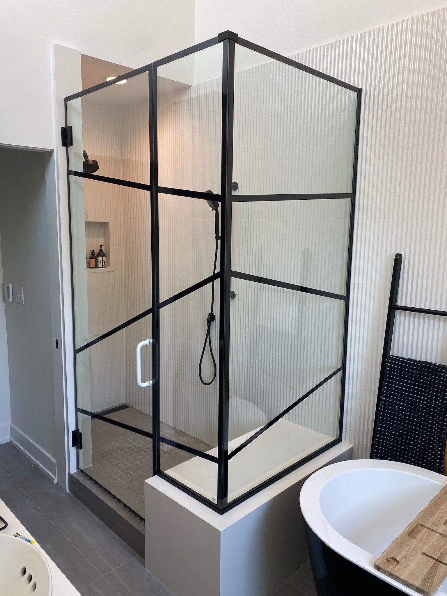 A bathroom with a walk in shower and a bathtub