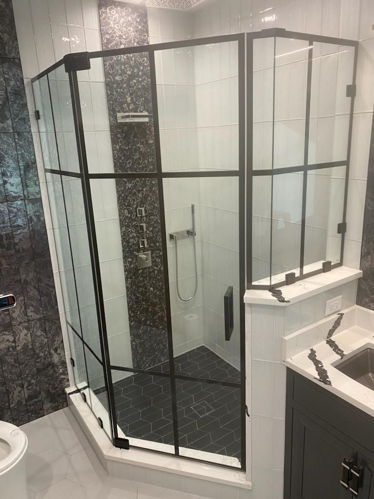 A bathroom with a shower stall and a toilet