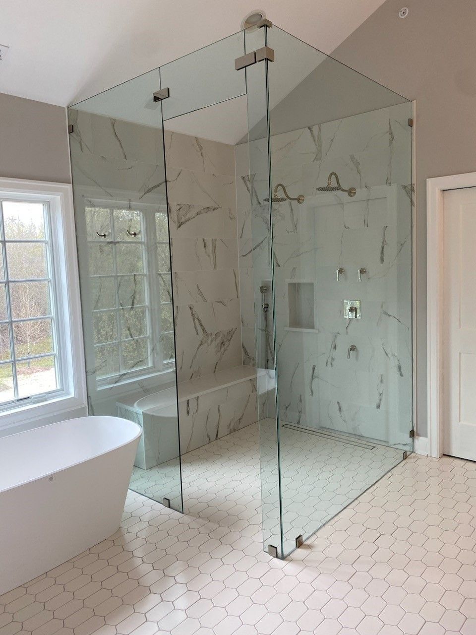 A bathroom with a walk in shower and a bathtub