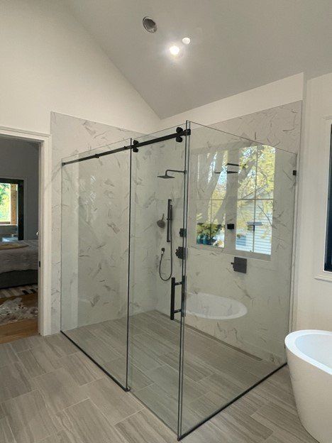 A bathroom with a walk in shower and a bathtub