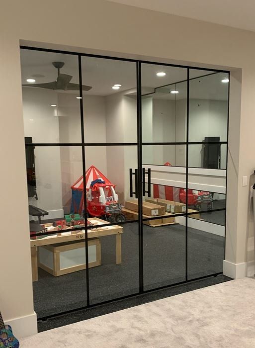 A room with a lot of mirrors and sliding glass doors