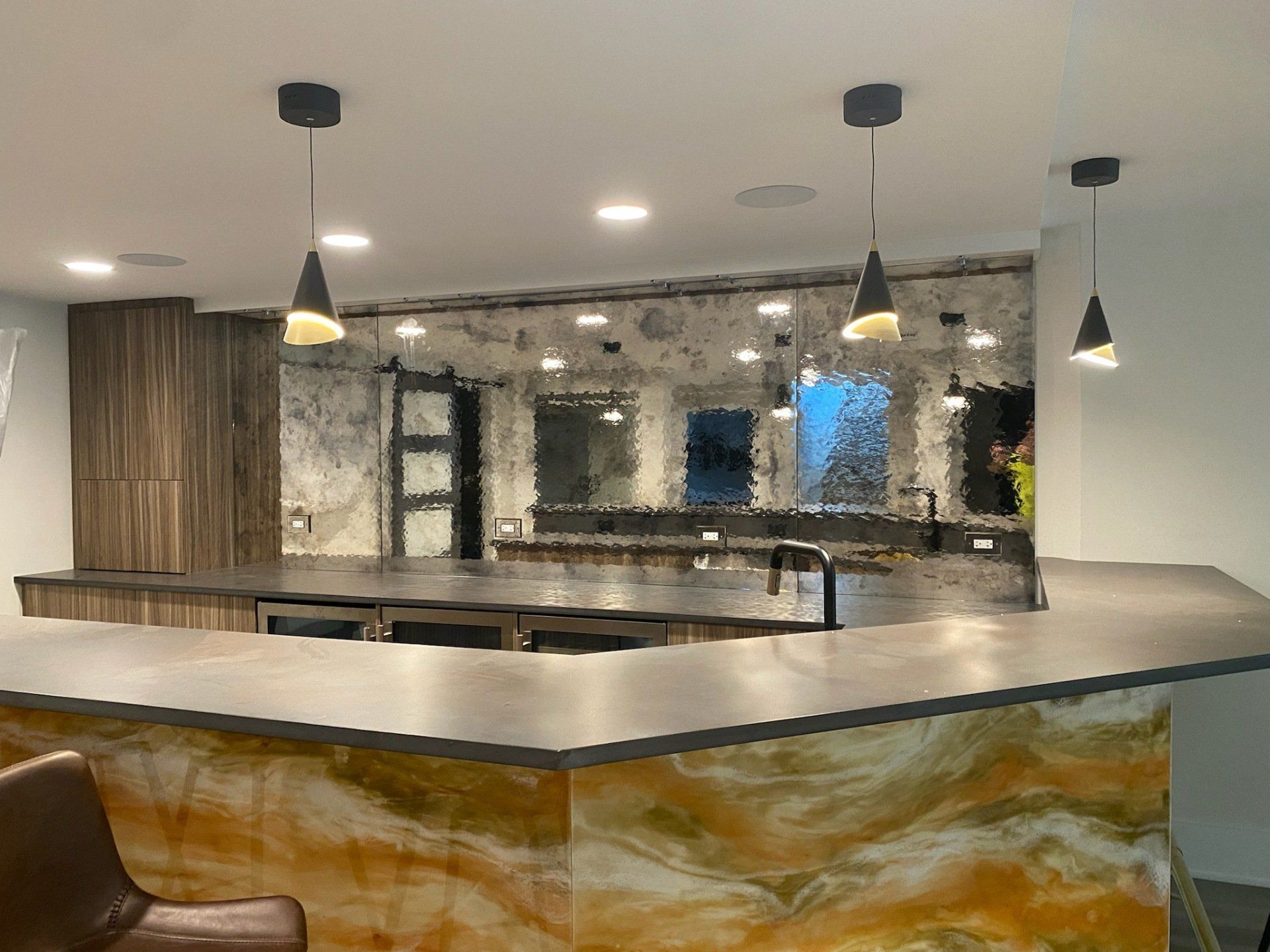 A kitchen with a large counter top and a stool