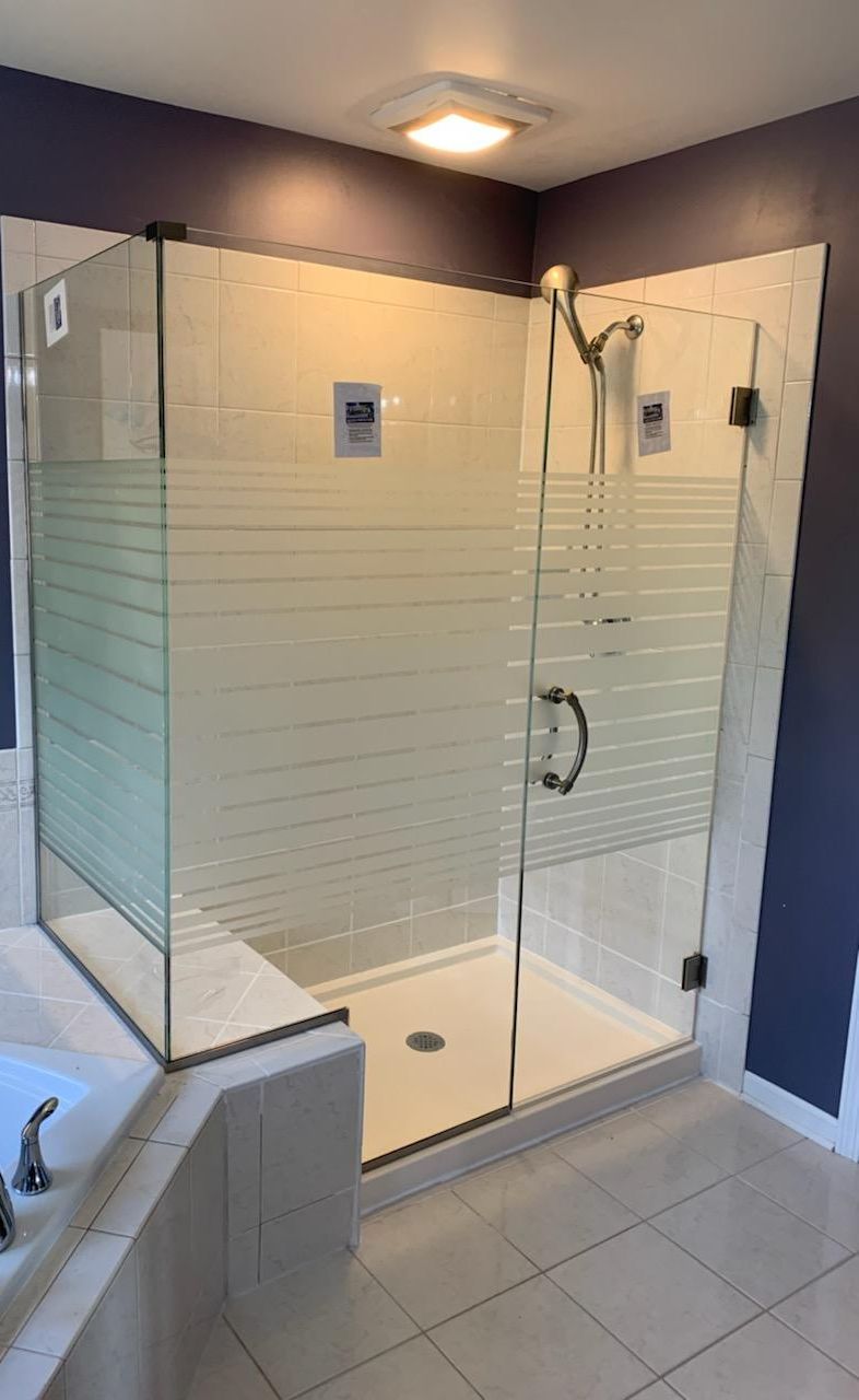 A bathroom with a walk in shower and a bathtub