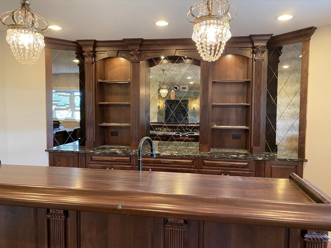 A kitchen with a large wooden bar and a sink