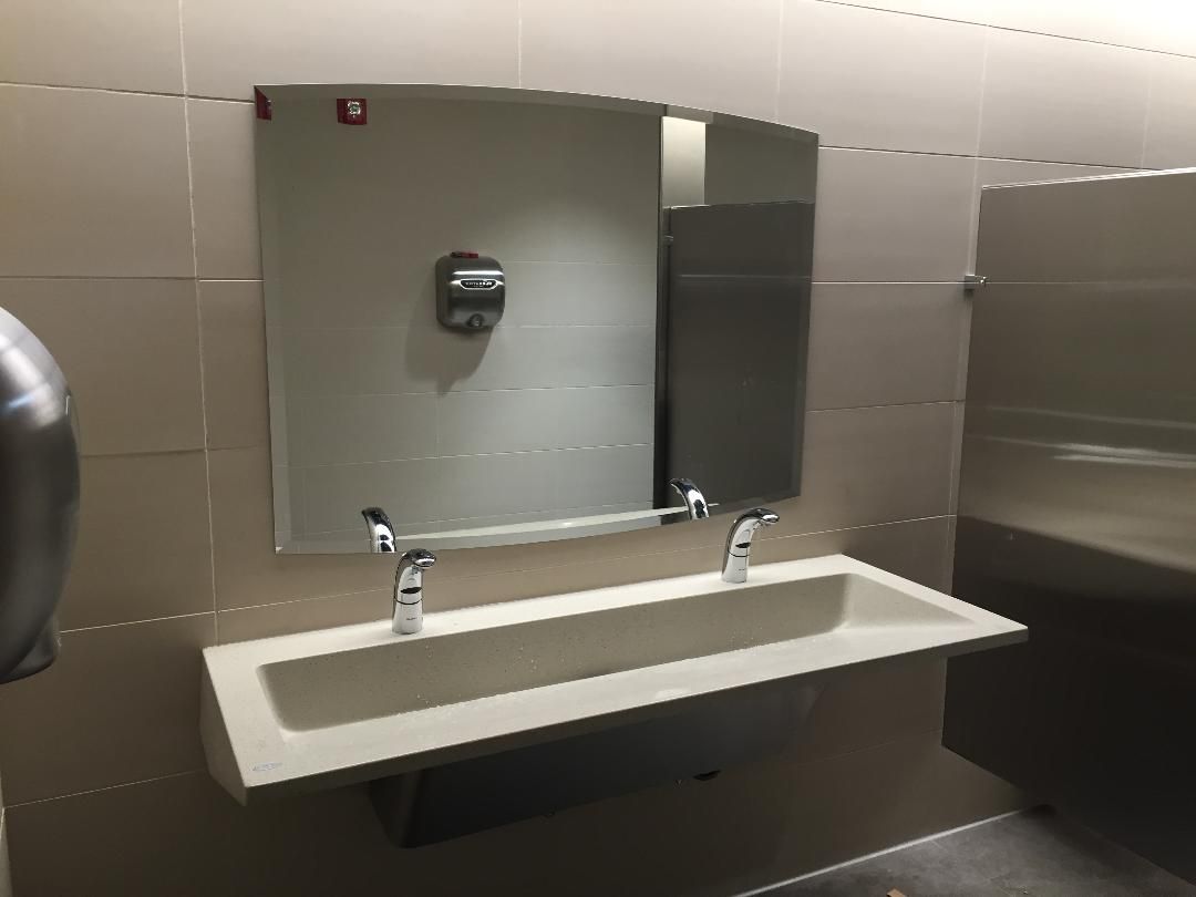 A bathroom with two sinks and a mirror